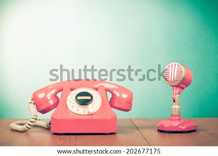 Retro pink telephone and microphone front mint green background