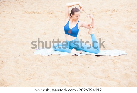 image of woman yoga sand