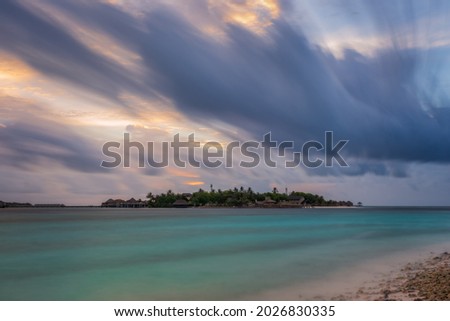 Tropical beach at resort, North Male Atoll, Republic of Maldives, Adaaran Prestige Vadoo resort hotel at sunset time. Long exposure picture in july 2021