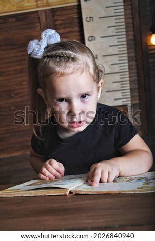 a girl of European appearance sits at a desk in a school uniform, teaches lessons, against the background of a blackboard for the text. Knowledge day.
Apples at school on a desk