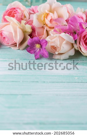 Fresh summer flowers roses, sweet peas, clematis on wooden background. Selective focus.