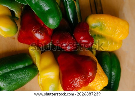 bright and juicy bell peppers on a wooden board. healthy food and vitamins to strengthen the immune system in the autumn period. sliced vegetables for freezing and canning. ingredients for the dish