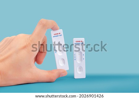 Hand holding Quick antibody detection test Coronavirus detection one step test kit. showing positive and negative result Fast COVID-19 serologic diagnostic test Self  antigen rapid test concept  Royalty-Free Stock Photo #2026901426