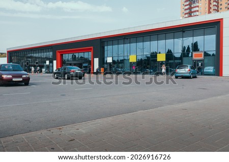 Supermarket outside with mockups of advertising signs. Supermarket Outdoor with glass showcase and car parking.