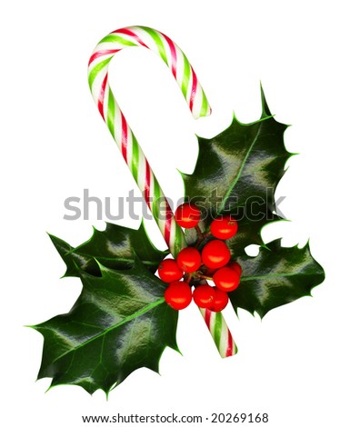 Clipping path. Candy cane with pretty holly leaves and berries on white background