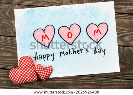 happy mothers day card, with drawing hearts on a paper