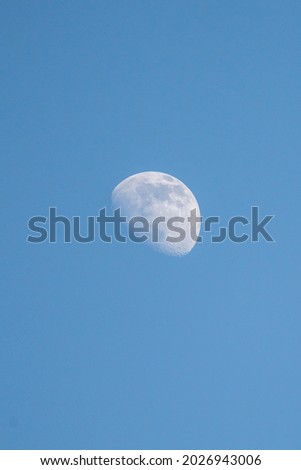 partial moon at dusk on blue sky