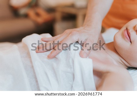 real doctor osteopath hands does physiological and emotional therapy for eight year old kid girl. pediatric osteopathy treatment session. alternative medicine. taking care of the child's health