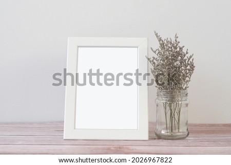 Mock up frame photo on wooden table. Copy space.