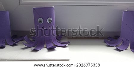 purple octopuses made of cardboard, decoration in the children's school. Royalty-Free Stock Photo #2026975358