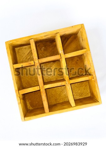 Small wooden shelf, consists of 9 square spaces. Isolated on white background.