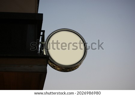 Mock-up of round shaped signage outside building