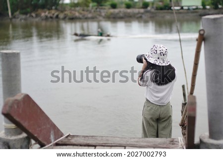                                An Asian girl taking photo