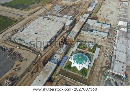 aerial shot of mosque surrounded by building construction