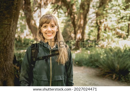 Portrait of young woman hiking in the Hoh Rainforest in Olympic National Park.