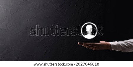 Businessman in suit holding out hand icon of user. Internet icons interface foreground. global network media concept,contact on virtual screens ,copy space.