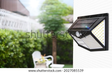 Small solar powered led light with motion sensor	 Royalty-Free Stock Photo #2027085539