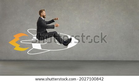 Side profile view happy smiling laughing man flying in air riding cartoon doodle rocket with burning blast off flame.Using creative power, developing business, reaching success, achieving goal concept