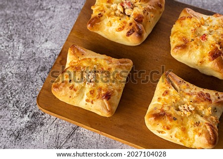 Baked snacks ​​- bread stuffed with cheese and sun-dried tom