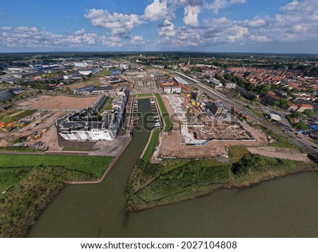 Construction plot Kade Zuid part of the new Noorderhaven neighbourhood at riverbed of the  IJssel in Zutphen, The Netherlands. Aerial industrial view of building site. Housing and urban management.