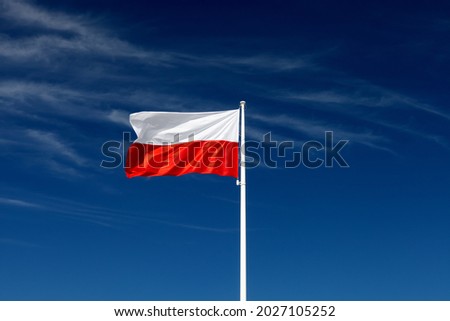 Beautiful Polish flag on a sunny day with blue sky on background Royalty-Free Stock Photo #2027105252
