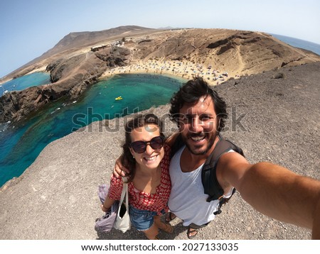 happy couple traveling in Canarie Islands taking a selfie photo in Lanzarote landscape. Beautiful moments in Lanzarote, Canarie, Spain