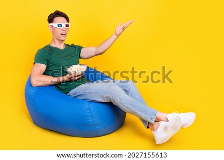 Full size photo of unhappy upset man sit bean bag chair wear glasses 3d watch tv isolated on yellow color background