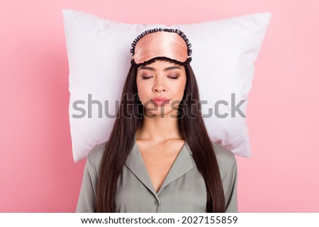 Portrait of attractive dreamy girl sleeping cosy comfy cushion bed time isolated over pink pastel color background