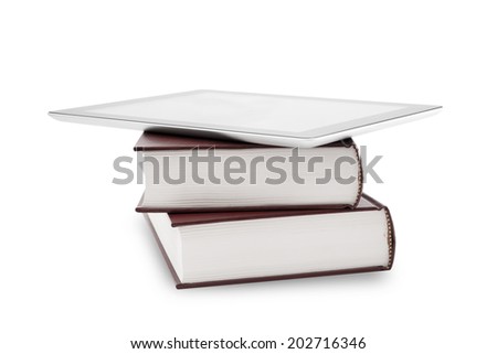 blank digital tablet and stack of books