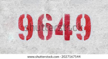 Red Number 9649 on the white wall. Spray paint. Number nine thousand six hundred forty nine.