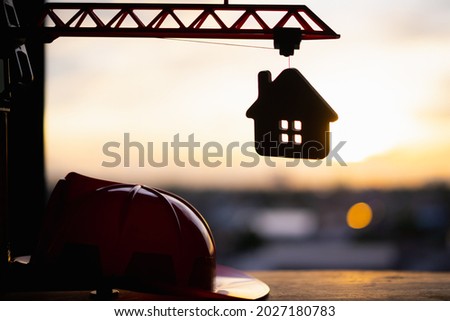 Wood house and on crane building model. financial plan, Real estate and property agent offer house concepts. selective focus on house model.