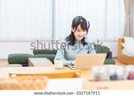 Beautiful young asian woman studying with a laptop computer,correspondence course Royalty-Free Stock Photo #2027187911