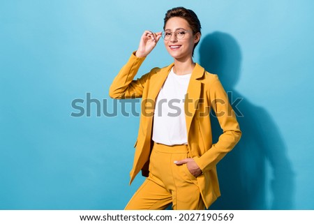 Portrait of attractive cheerful skilled woman expert posing touching specs isolated over bright blue color background Royalty-Free Stock Photo #2027190569