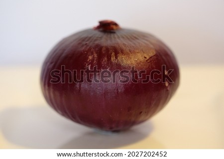 A whole red onion - studio shot.