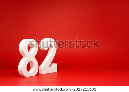 Eighty Two ( 82 ) white number wooden Isolated Red Background with Copy Space - New promotion 82% Percentage   Business finance or birthday Concept - advertise banner picture online with copy space
