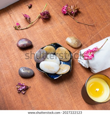 Motivational inspirational stones with writings. Serenity, gratitude, passion, love on a red table background Royalty-Free Stock Photo #2027222123