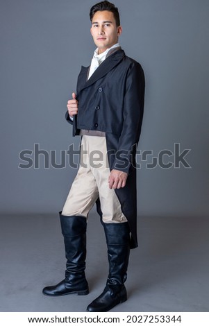 A Regency gentleman against a studio backdrop Royalty-Free Stock Photo #2027253344
