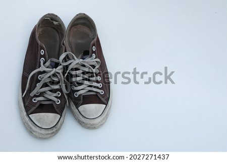 worn torn used dirty rubber shoes isolated