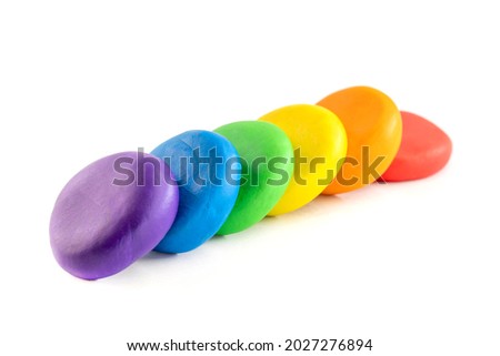 Multicolored circle shape plasticine placed on a white background. Play dough