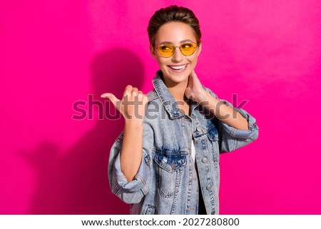 Photo of young curious happy positive woman point finger empty space thumb sale isolated on pink color background