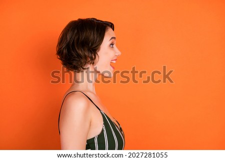 Profile side photo of young excited girl amazed shocked happy smile look empty space isolated over orange color background Royalty-Free Stock Photo #2027281055
