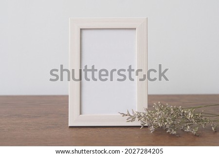 Mock up frame photo on wooden table. Copy space.