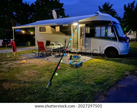 Picture shows a Caravan  Camper at a campside in the evening