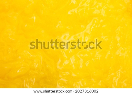 yellow texture of juicy peach pulp closeup macro. Royalty-Free Stock Photo #2027316002