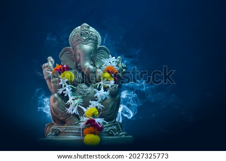 lord ganesha sclupture over dark background. celebrate lord ganesha festival. Royalty-Free Stock Photo #2027325773