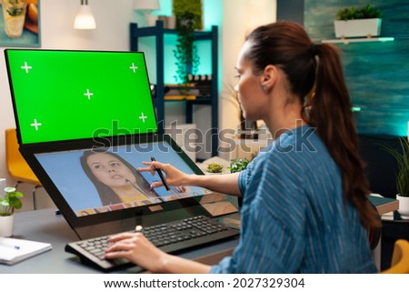 Digital editor using green screen and retouching software for pattern production on computer. Specialist woman with chroma key on display, mockup template and isolated virtual background
