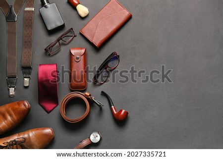 Stylish male accessories on dark background