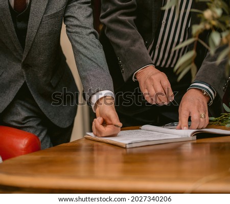 unidentifiable model signing a wedding contract