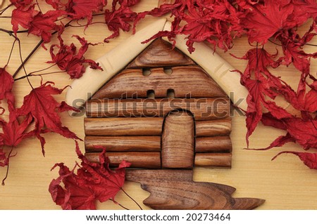 Woodcraft cabin house and dry maple leaves