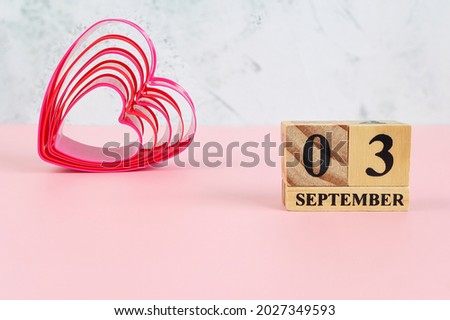 September 3rd. Hello September, Cube wooden calendar showing date on 3 September, Wooden calendar with date on a light background.